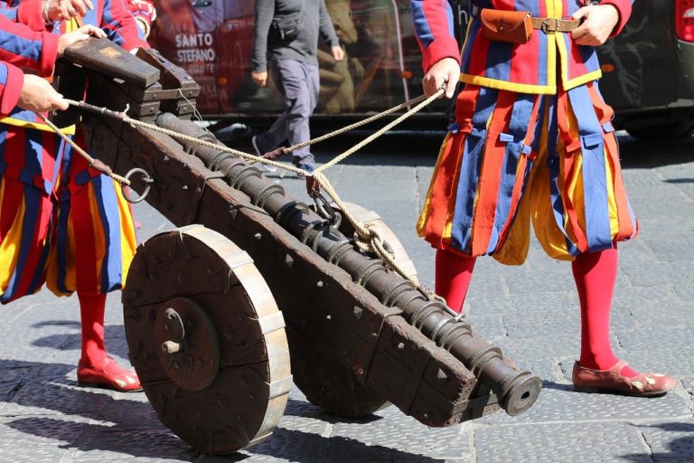 two costumed people pull a cannon