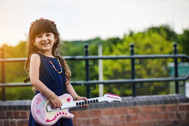 Child playing a guitar