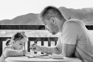 A dad works with his child on homework